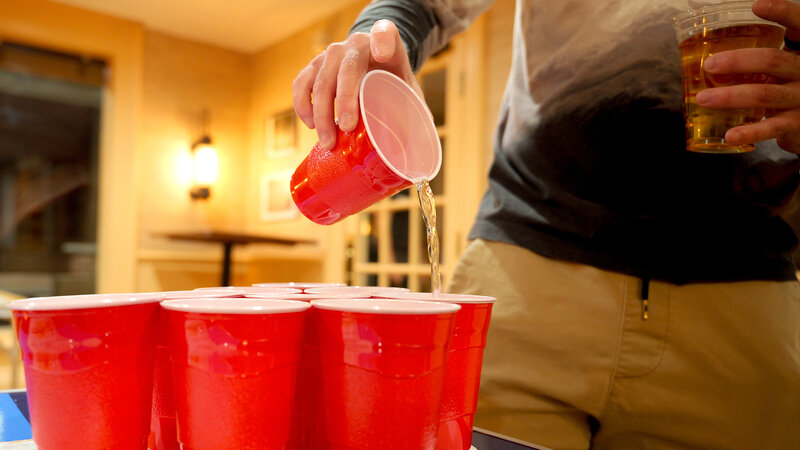 Pong player pouring water into a cup